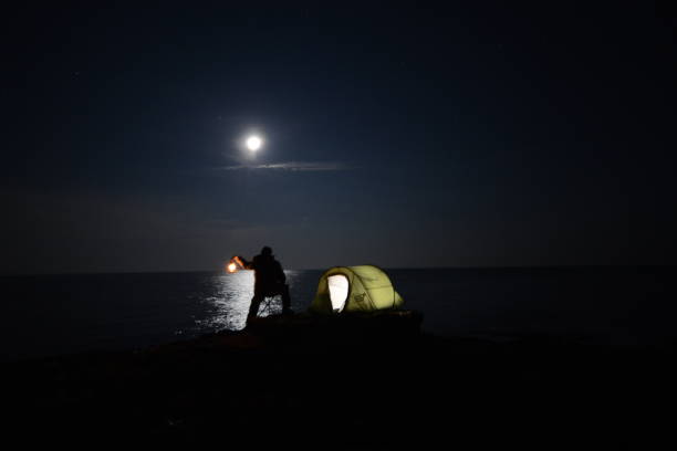 istock A tent glows under a night sky full of stars. 676033938