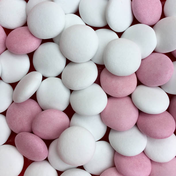 istock High angle view of white and pink chocolate drops 676033948