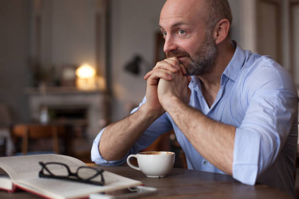 istock Man looks thoughtfully aside, planning the day. 676034606