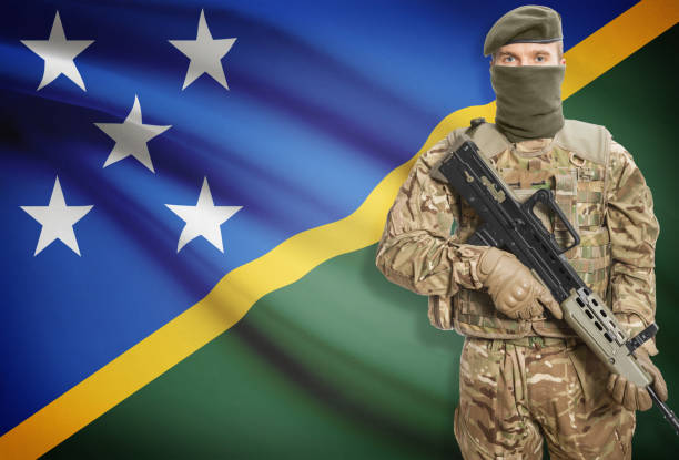 istock Soldier holding machine gun with flag on background series - Solomon Islands 676038732