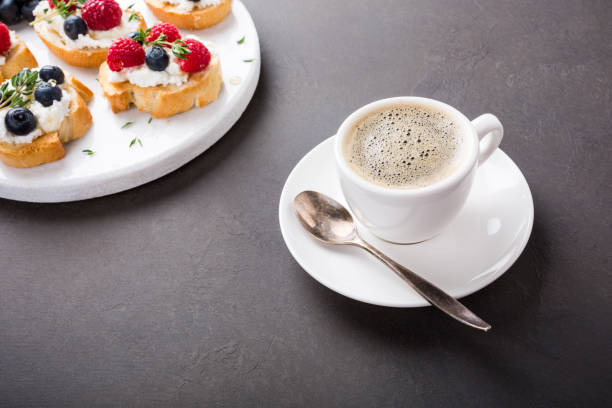 istock Cup of coffee with fruit sandwiches 676043192