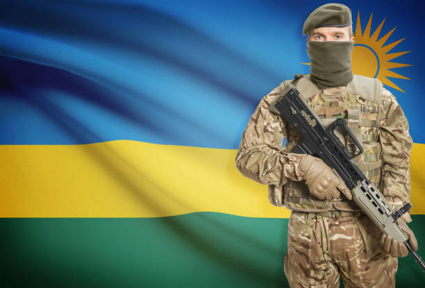 istock Soldier holding machine gun with flag on background series - Rwanda 676043568