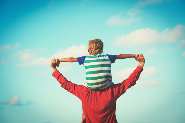 istock happy father and son playing on sky 676051428