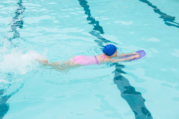 istock Girl swimming in the pool 676053602