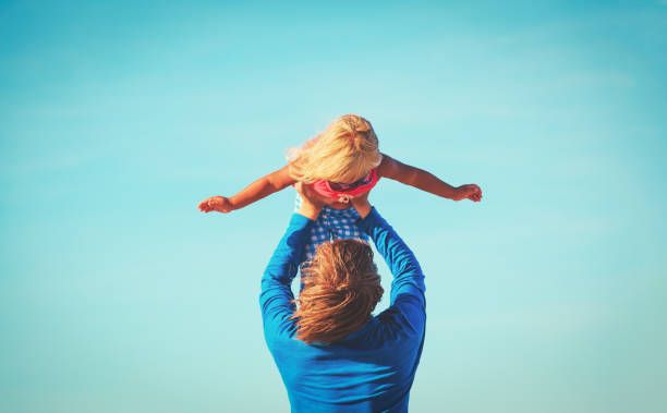 istock Father and little daughter play at sky 676053986