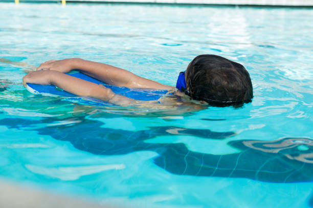 istock Boy swimming in the pool 676057154