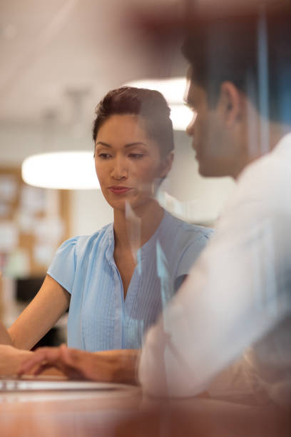 istock Business colleagues discussing seen through glass 676060224