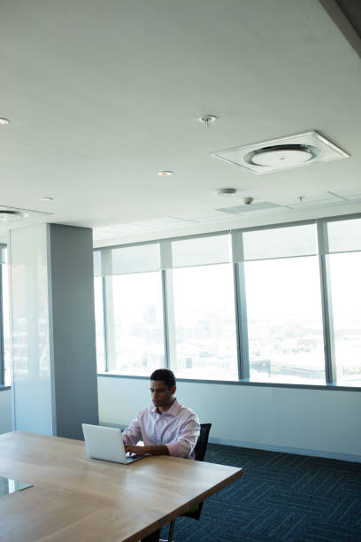 istock Businessman typing on laptop in conference room 676066356
