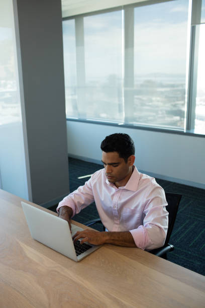 istock High angle view of businessman typing on laptop 676066800