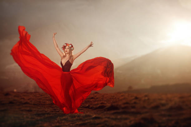 Dancing and moving blond lady on a white background holding red fiber