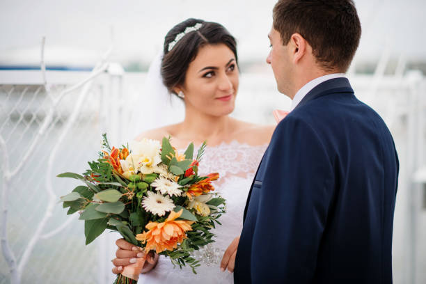 istock Wedding couple stay on the pier berth at cloudy day. 676093108