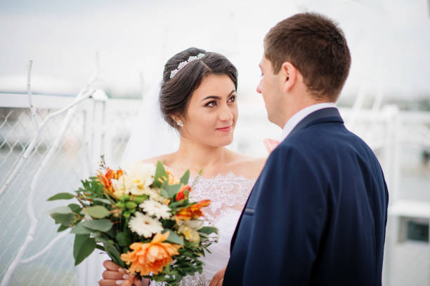 istock Wedding couple stay on the pier berth at cloudy day. 676093498