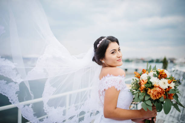istock Brunette bride stay on the pier berth at cloudy day. 676094552