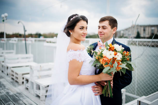 istock Wedding couple stay on the pier berth at cloudy day. 676094766
