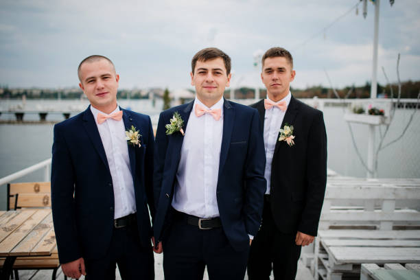 istock Groom with best mans posed on the pier berth at cloudy wedding day. 676094924