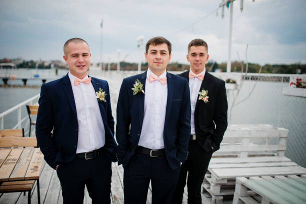istock Groom with best mans posed on the pier berth at cloudy wedding day. 676094992