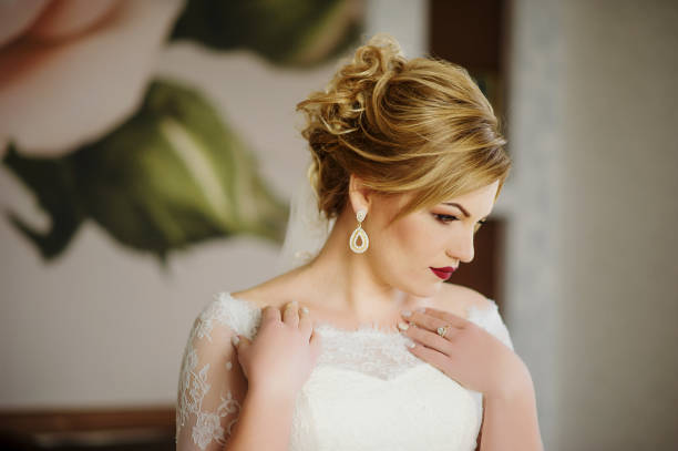 istock Blonde bride at wedding day on her room in morning. 676131320