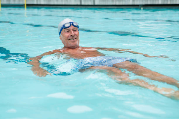 istock Senior man swimming in pool 676139690