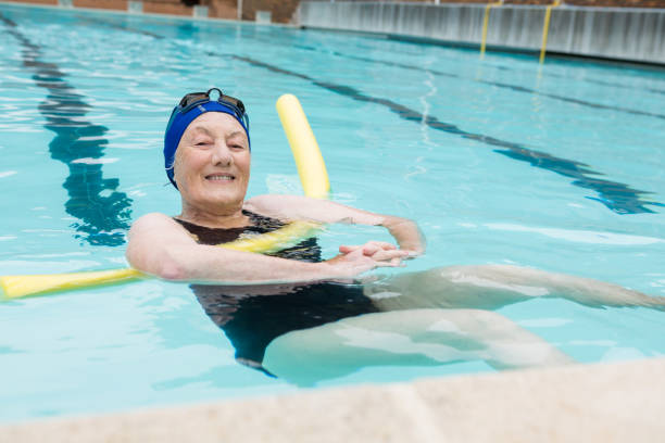 istock Senior woman swimming in pool 676139996