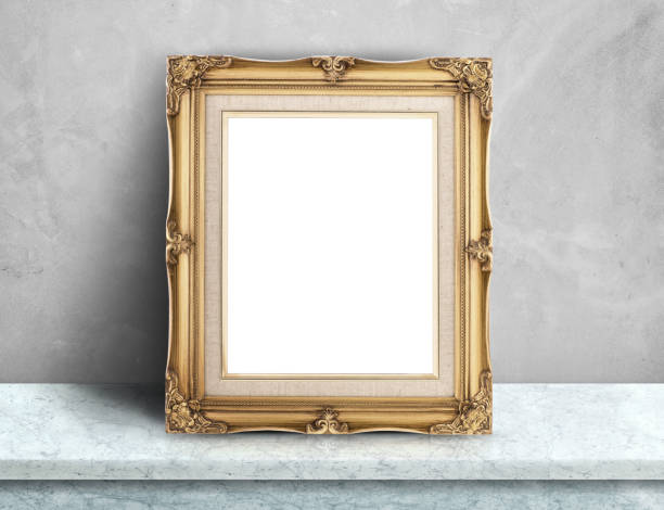 istock Blank Gold victorian picture frame on white marble table at grey concrete wall,Template mock up for adding your design and leave space beside frame for adding more text. 676144700