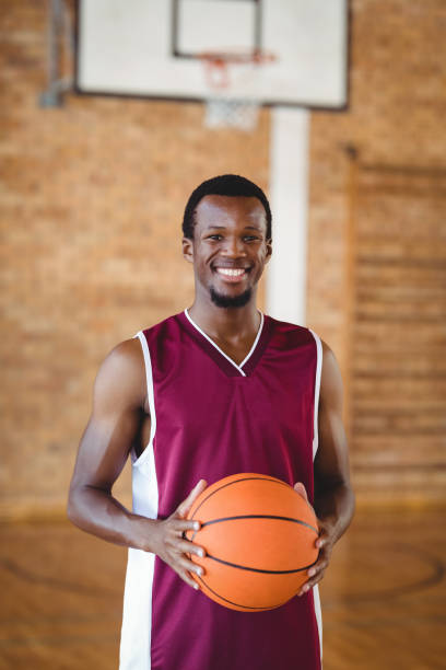 istock Smiling basketball player holding a basketball 676151856