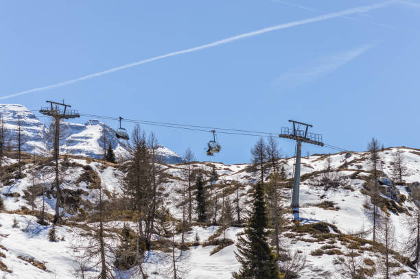 istock Ski lift between pine trees on the Dolomites Mountains 676155766