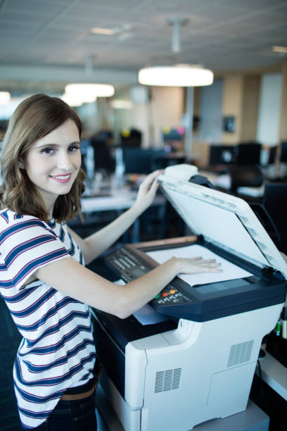 istock Portrait of businesswoman using copy machine in office 676158018