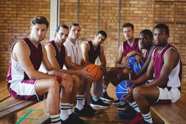 istock Confident coach and basketball player sitting on bench 676162830