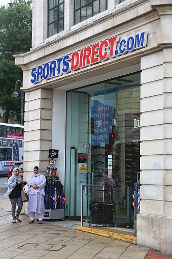 LEEDS, UK - JULY 11, 2016: People walk by Sports Direct store in Leeds, UK. Sports Direct offers discount sports wares in 670 stores worldwide.