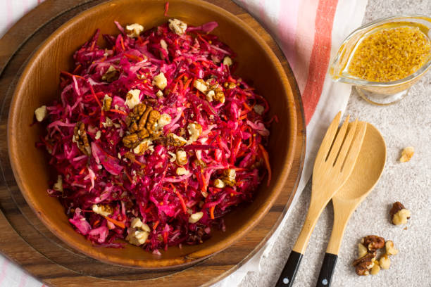 istock Cabbage beetroot carrot salad with nuts  in a wooden bowl closeu 676183202