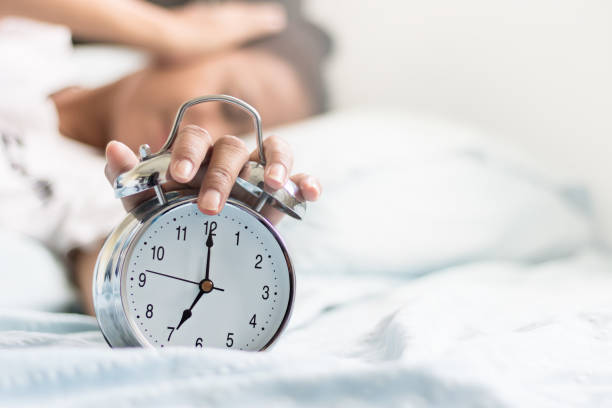 istock Clock on the bed in the morning. 676184230