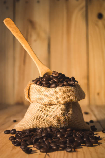 istock Hot coffee cup and bean on wood background vintage tone 676196744