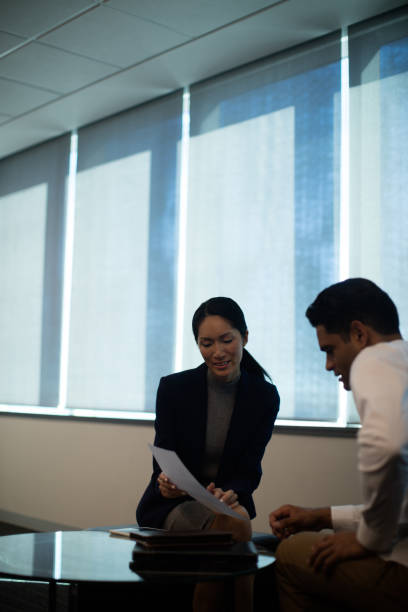 istock Business people discussing over document at office 676223332
