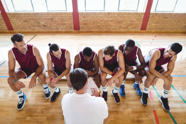 istock Coach explaining game plan to basketball players 676234340