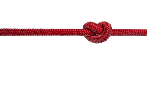 red rope with knot - knotted rope on white background