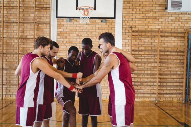 istock Team of basketball players stacking hands 676236464
