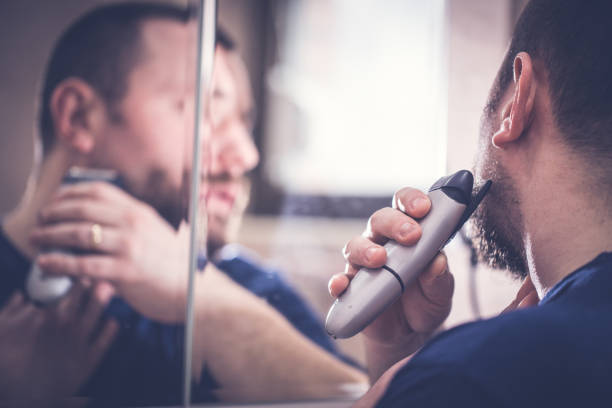 istock Man shaving with electric razor 676248432