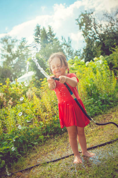 istock Happy girl playing with water in summer 676249128
