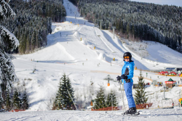 istock Female skier on a ski slope at a sunny day 676253326