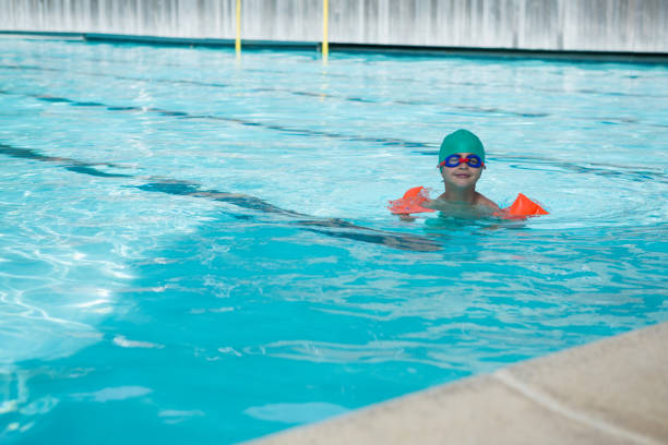 istock Boy swimming in the pool 676262734