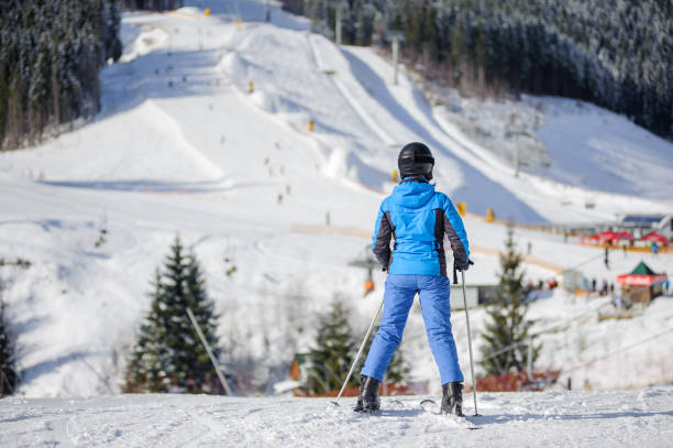 istock Female skier on a ski slope at a sunny day 676273174