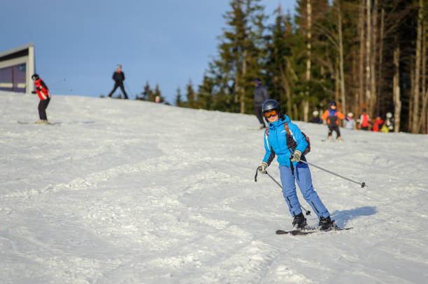 istock Female skier skiing downhill at ski resort 676273842