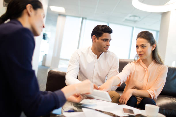 istock Young business people discussing over documets at office 676310736
