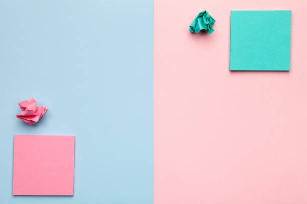 istock Sticky Notes with Crumbled Paper Balls on Pastel Background 676310896