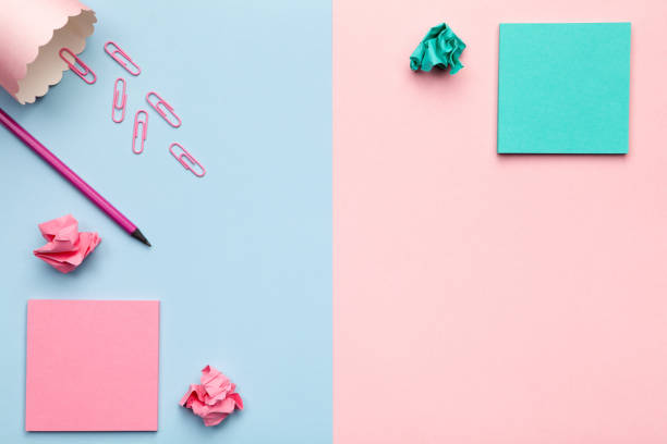istock Sticky Notes with Crumbled Paper Balls on Pastel Background 676311346