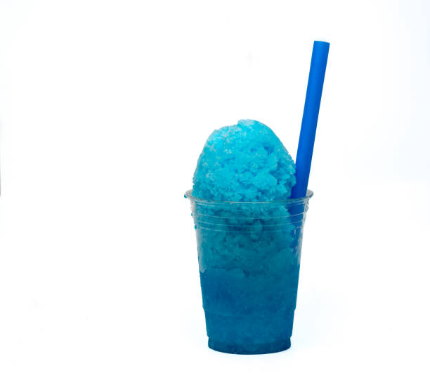 istock Blue Raspberry Hawaiian Shaved Ice or Snow cone dessert treat in a clear plastic cup. 676312452