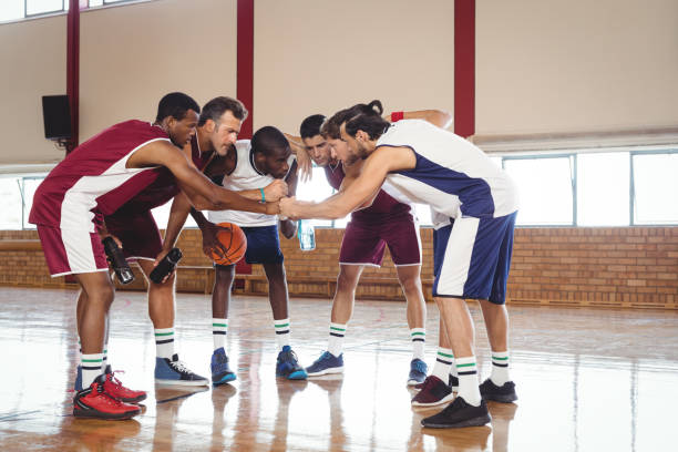 istock Basketball players forming a handstack in the court 676314536