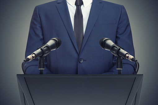 Businessman or politician making speech from behind the pulpit