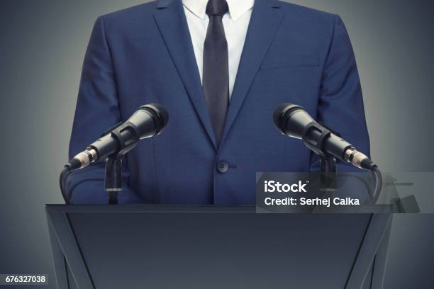 Businessman Or Politician Making Speech Behind The Pulpit Stock Photo - Download Image Now