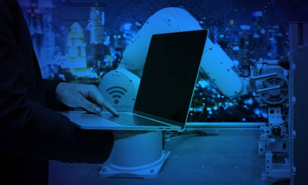 istock Industry 4.0 internet of things concept. Engineer finger point to laptop for control automation wireless robot machine arm and circuit board industrial graphic background in smart factory. Blue tone 676338174